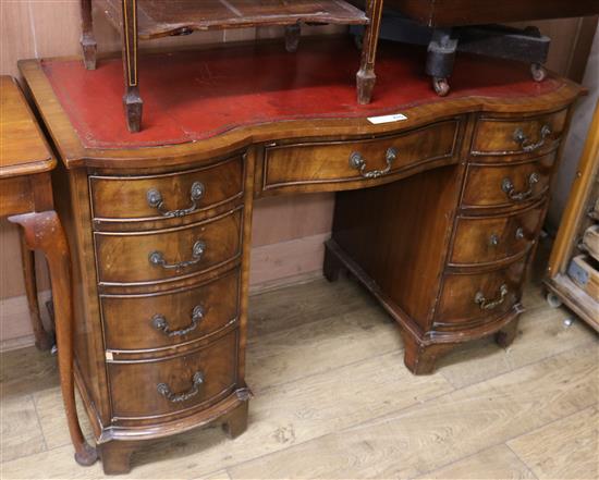 A reproduction Georgian style shape fronted mahogany twin pedestal desk, H.75cm W.105cm